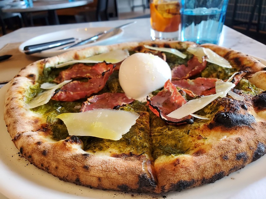 a pizza with a ball of burrata in the center