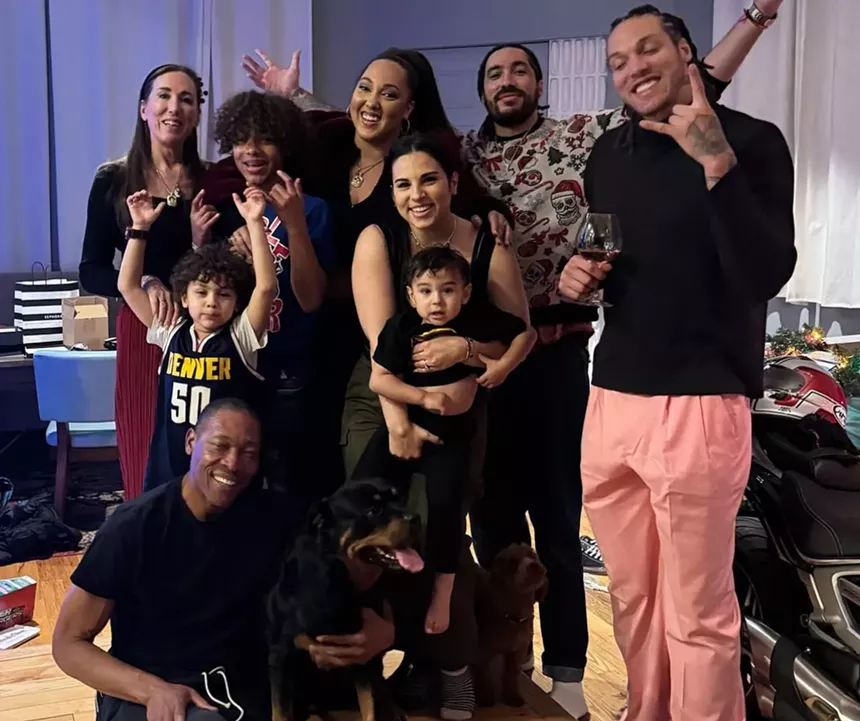 Denver Nuggers star Aaron Gordon posing with friends and family for a photo.