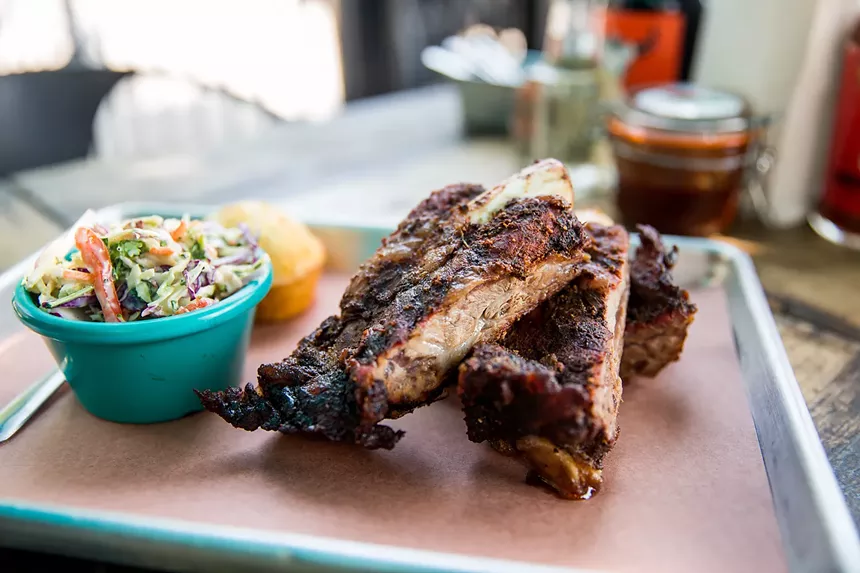 barbecue robs and a side of cole slaw on a tray