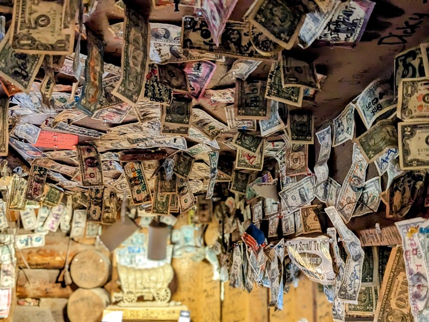 dollar bills hanging from a wall and ceiling