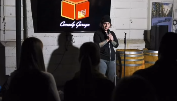 Comedian in background at a show.