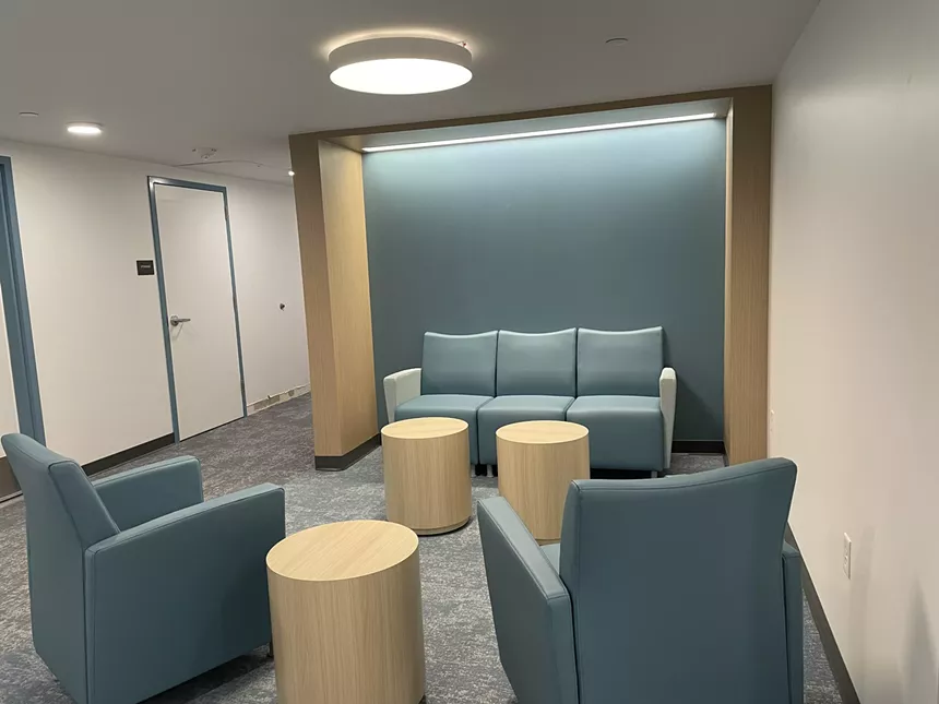 A room with couches and stools.