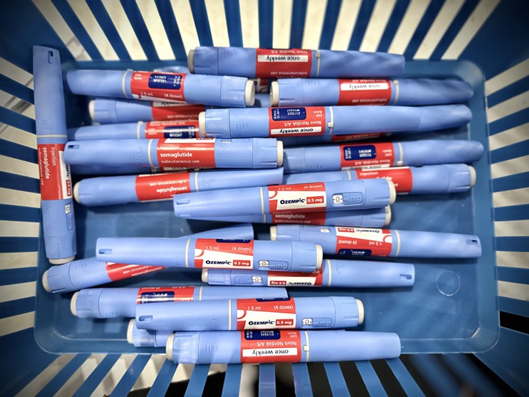 Basket of blue Ozempic syringes