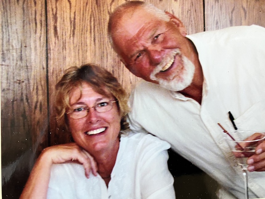 A man and woman, Margerie Hicks and Doug Schuler, posing together for a picture.