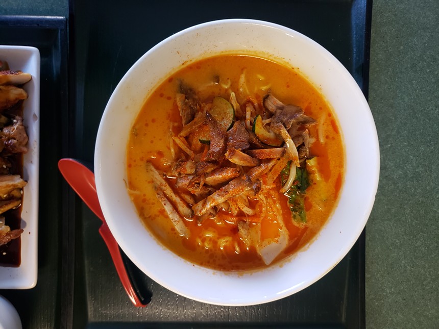 a bowl of soup with orange broth