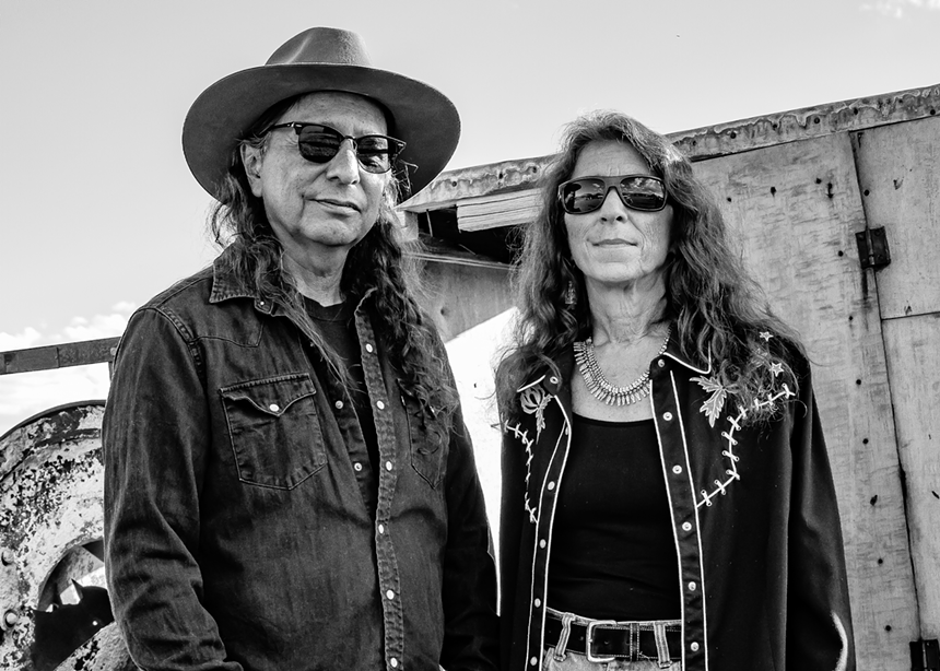 man in hat and woman in sunglasses