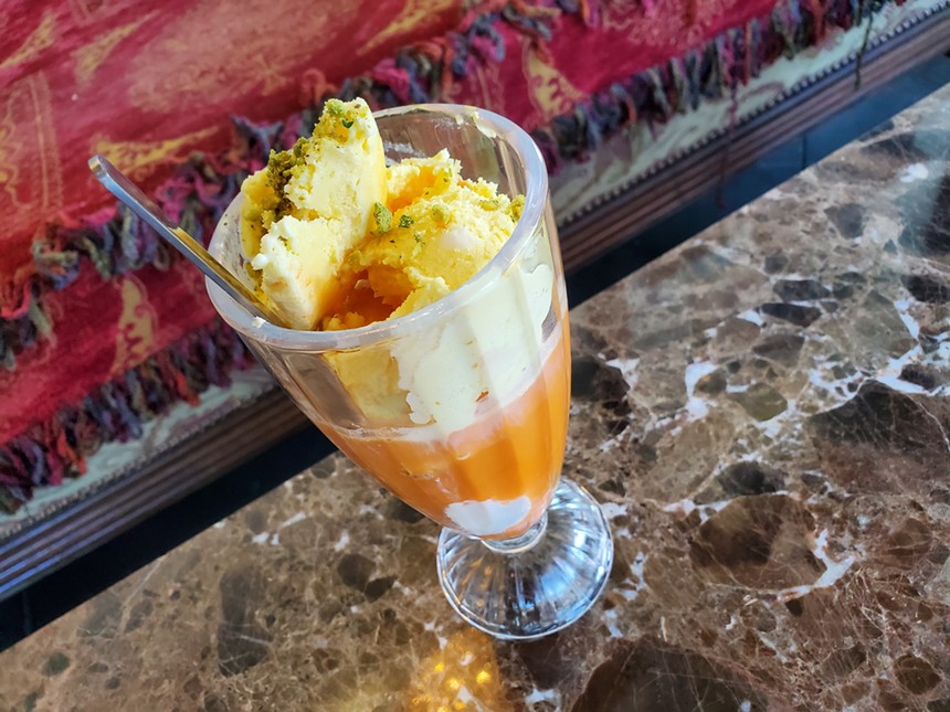 an ice cream float made with carrot juice in a glass
