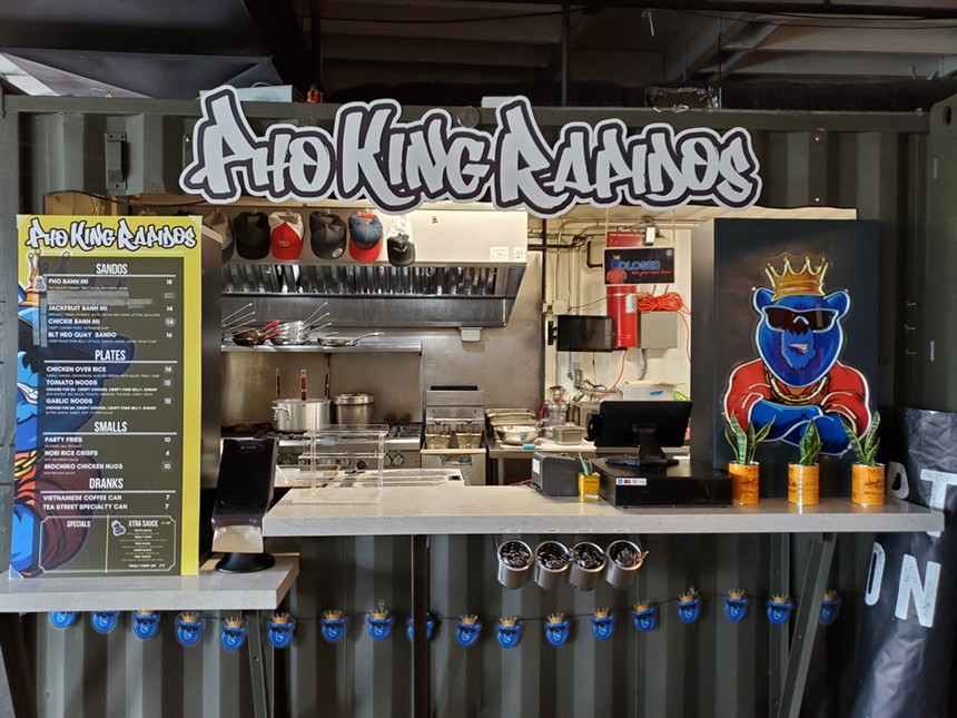 a food hall stall with a blue bear mascot painted on a wall