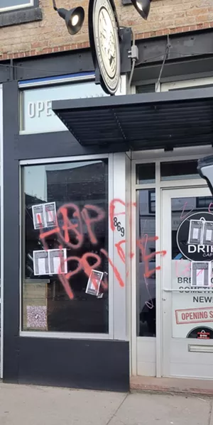 Graffiti scrawled on a window at The Drip Cafe in Denver, Colorado