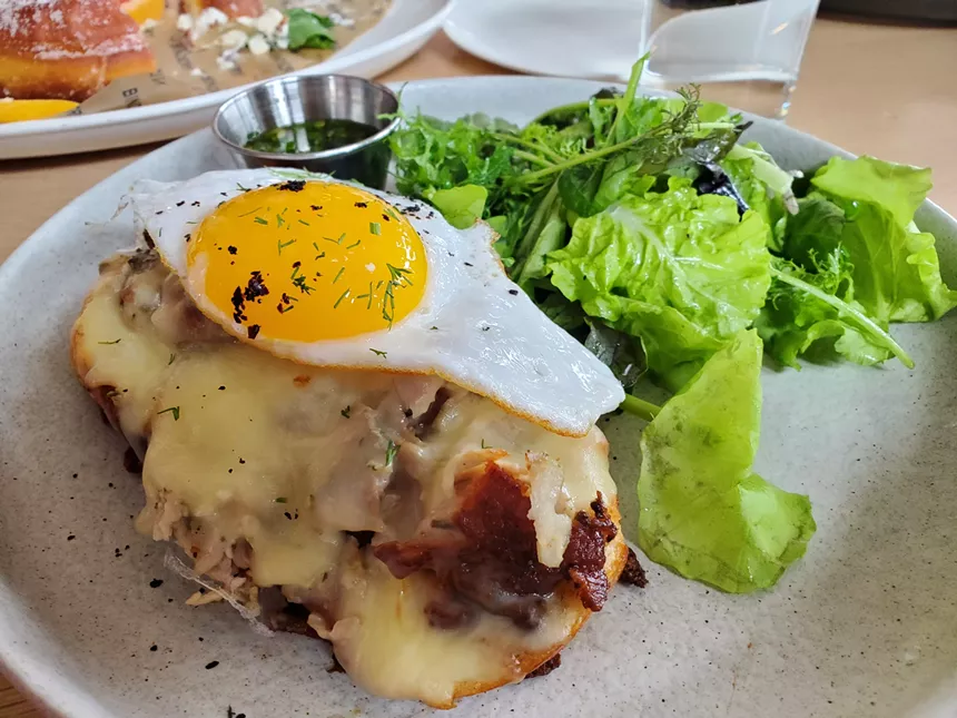 an open-faced sandwich with a sunny side up egg on top