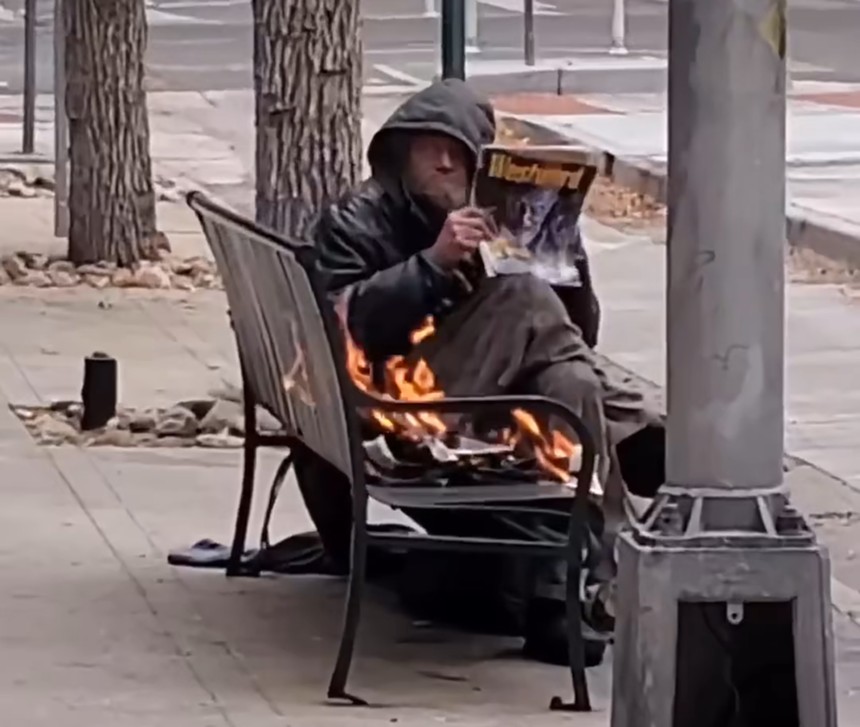 A homeless man in Denver, Colorado, reading an issue of Westword.