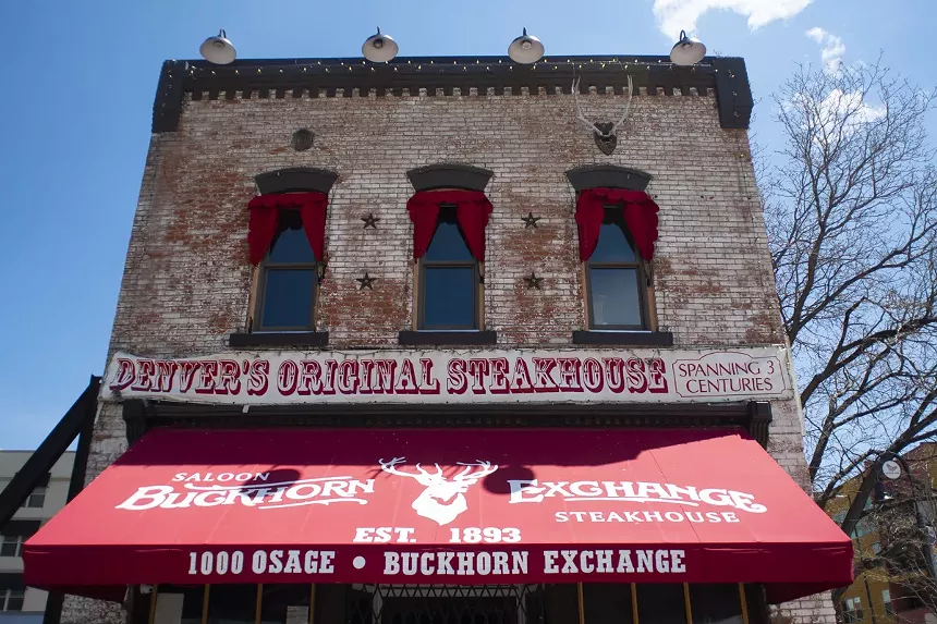 a brick building with a red awning