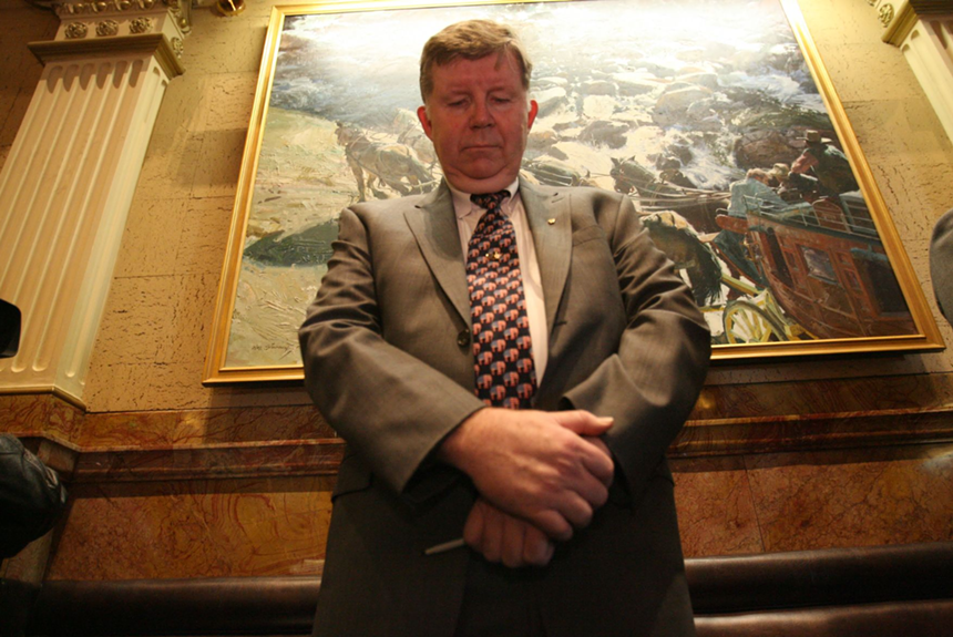 Douglas Bruce bows his head for the morning prayer on the House floor.