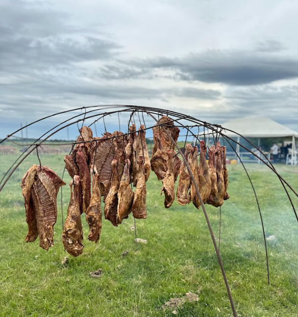 meat hanging on an arch outdoors