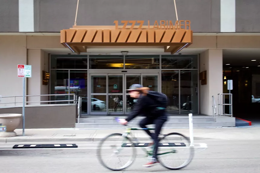 A bicyclist riding by the Windsor Condos at 1777 Larimer Street.