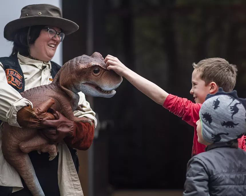 child pats T-Rex