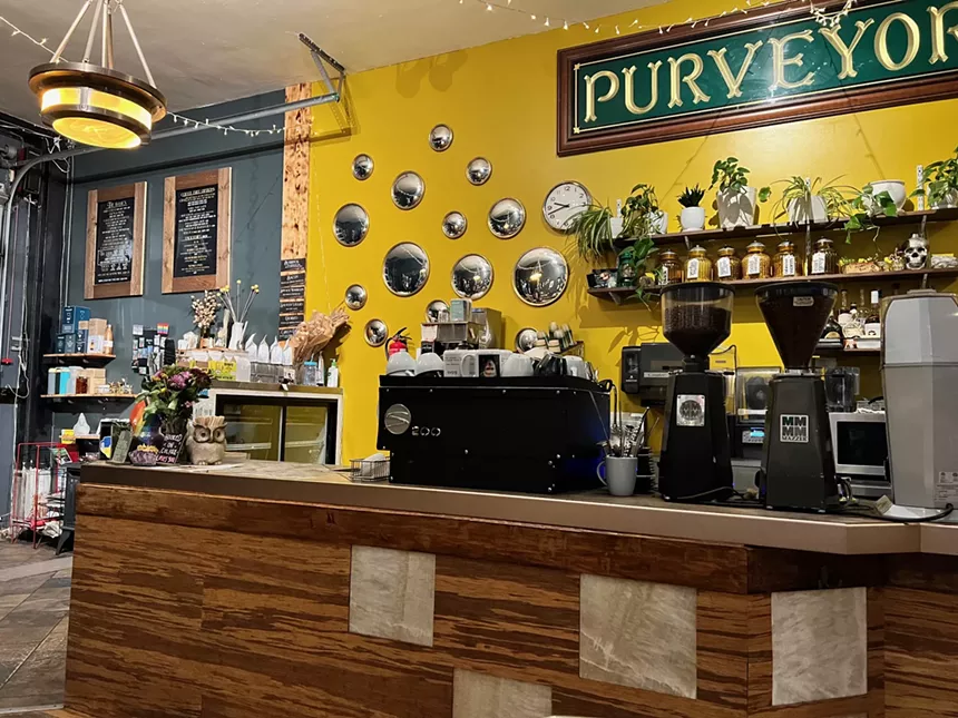 interior of a coffee shop with a yellow wall