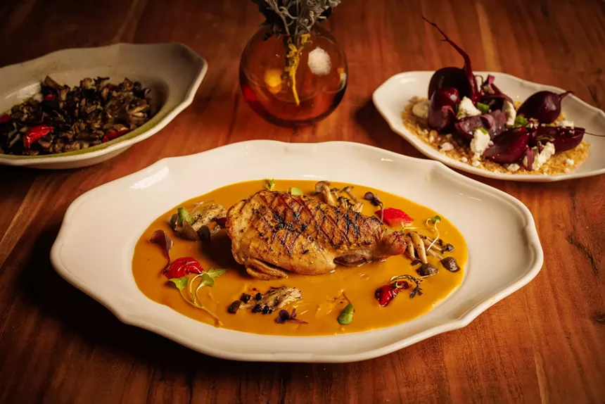 rabbit leg on a plate with a yellow sauce