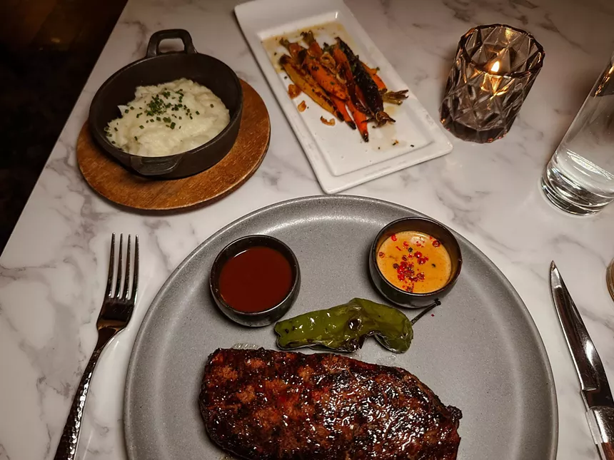 steak on a plate with potatoes and carrots