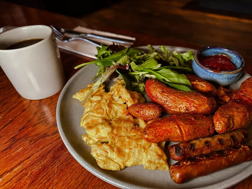 breakfast sits in a plate on a wood table