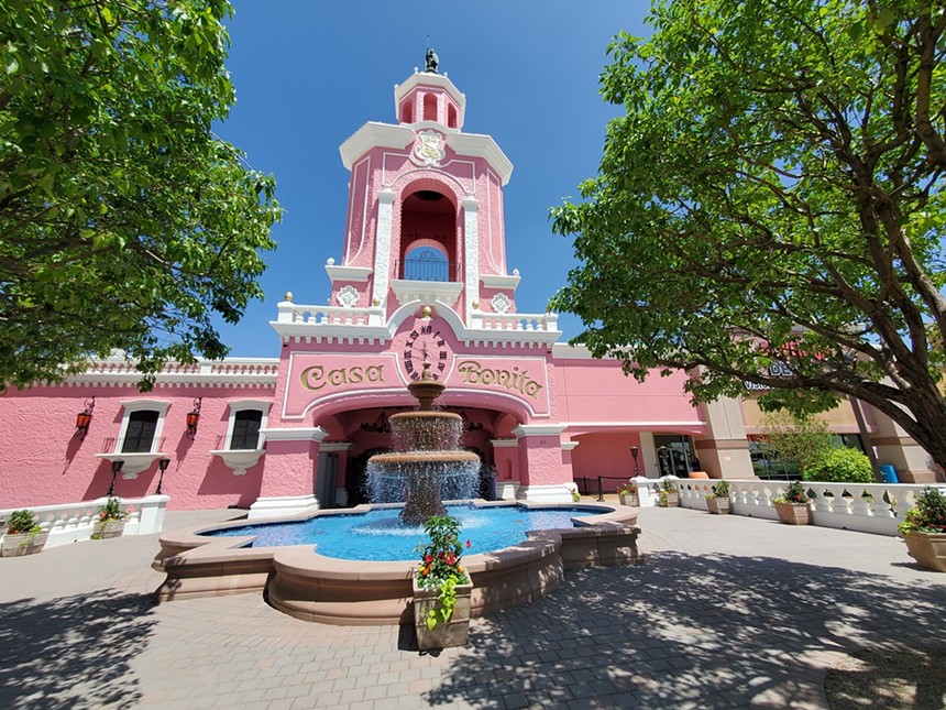 Fountain and pink exterior of Casa Bonita