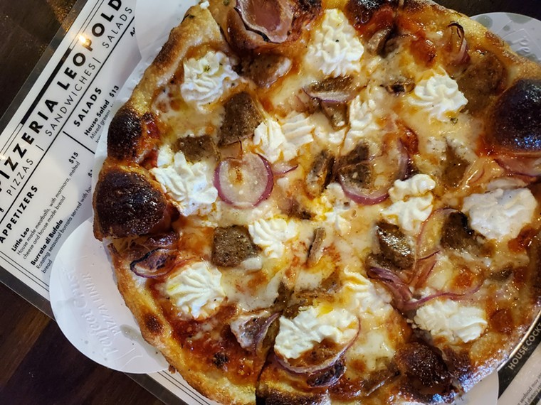 a pizza topped with meatballs, onions and ricotta