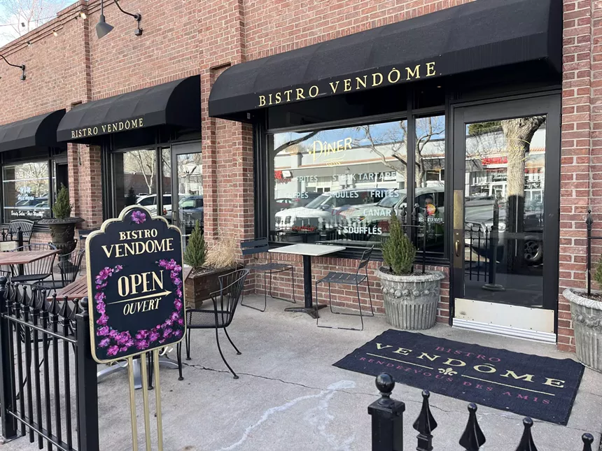 black awning over the front entrance of a restaurant
