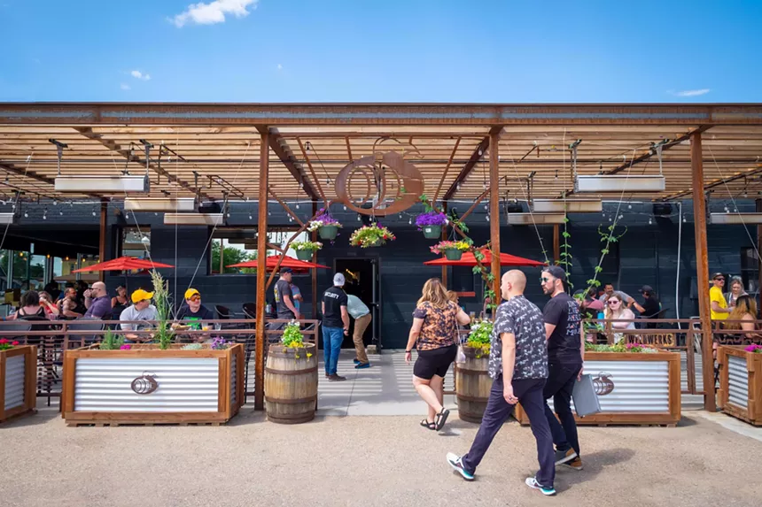 Brewery facade with people on a patio.