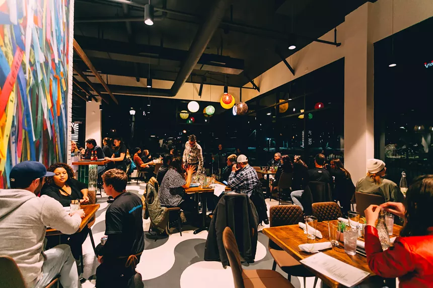 people sitting at tables in a dining room