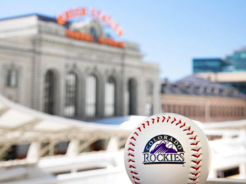 a baseball with a building in the background