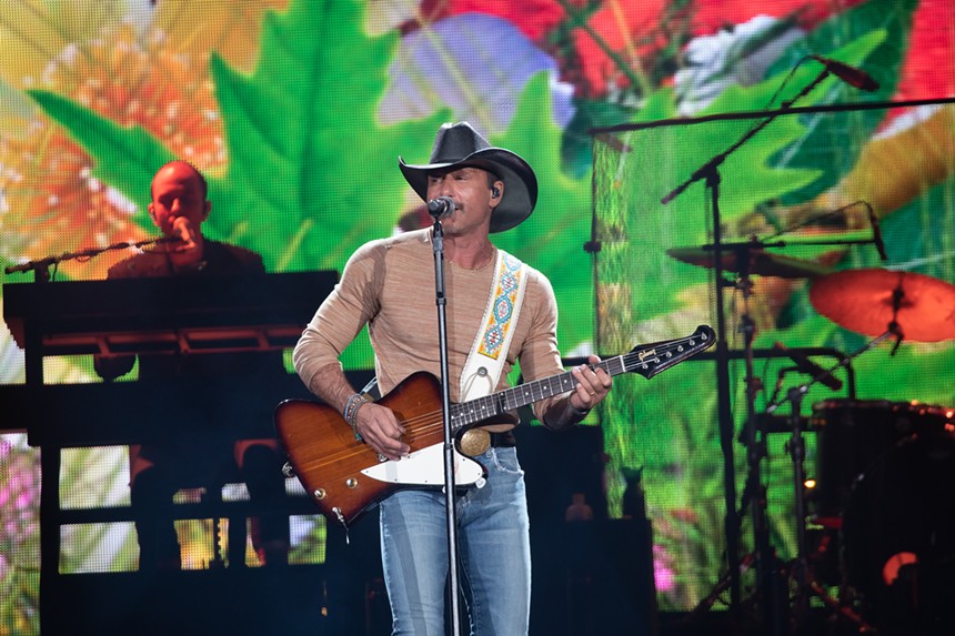 man in cowboy hat playing guitar