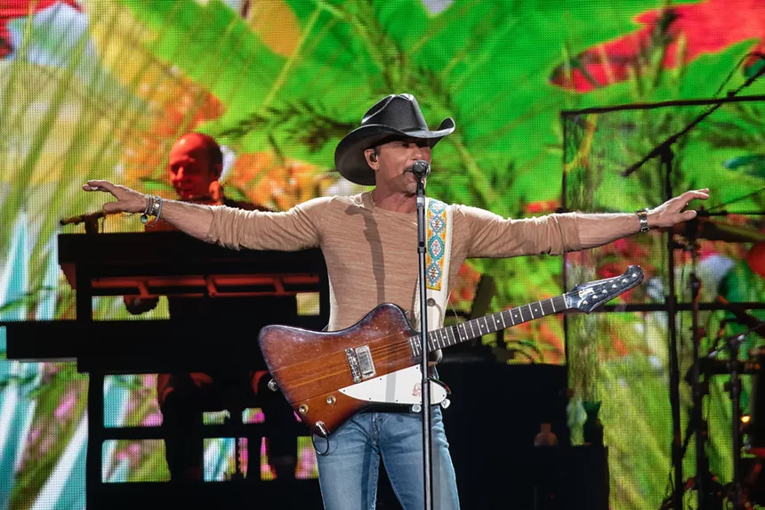 man in cowboy hat with a guitar