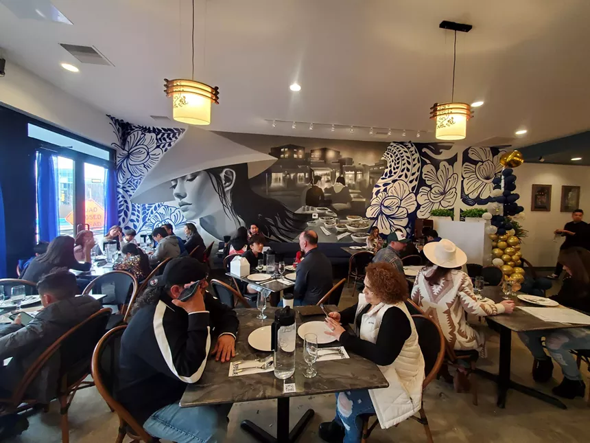people sitting at tables inside a restaurant