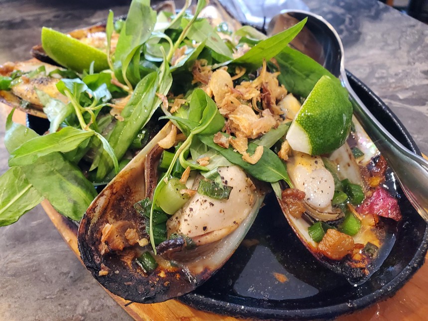 grilled mussels topped with herbs, scallion and fried onions