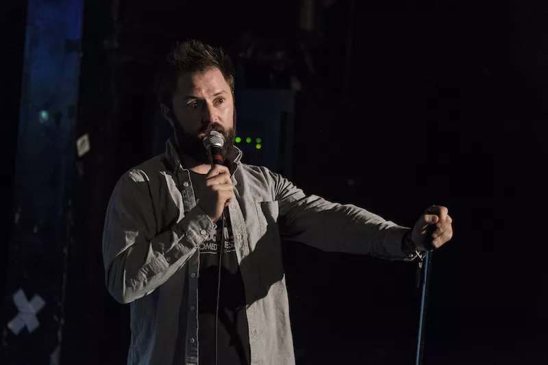 comedian at a microphone