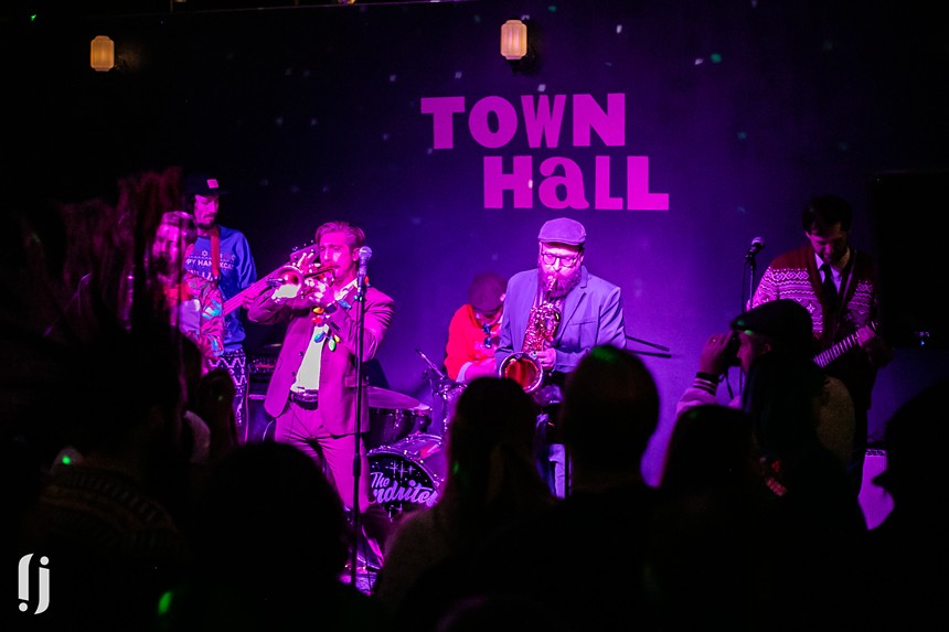 A band playing on Town Hall's dimly lit stage