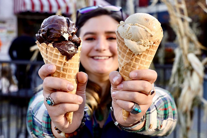 person holding two ice cream cones