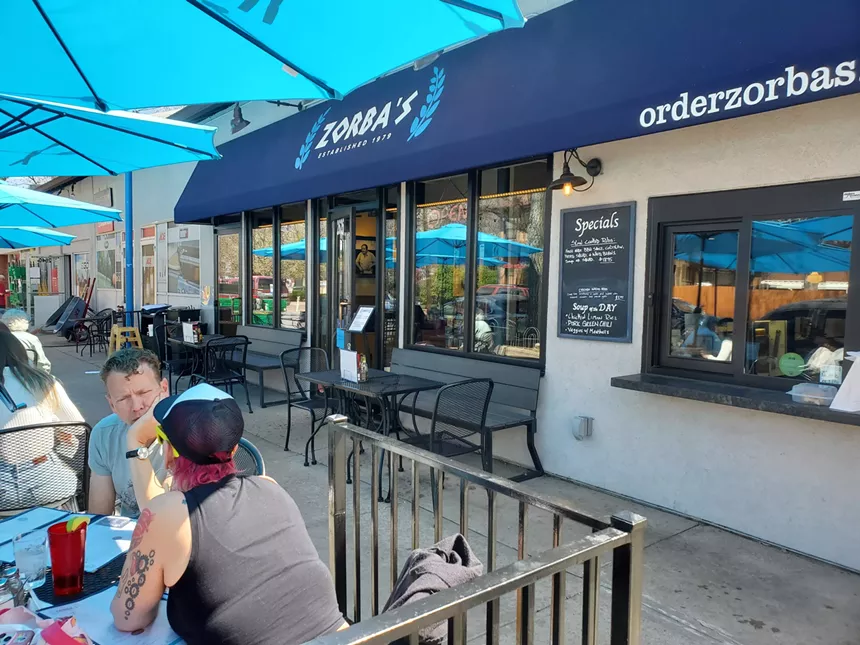 blue awning over the entry of a restaurant