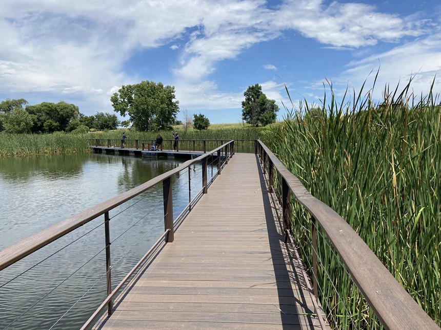 An elevated walkway crossing a lake at Rocky Mountain Arsenal National Wildlife Refuge
