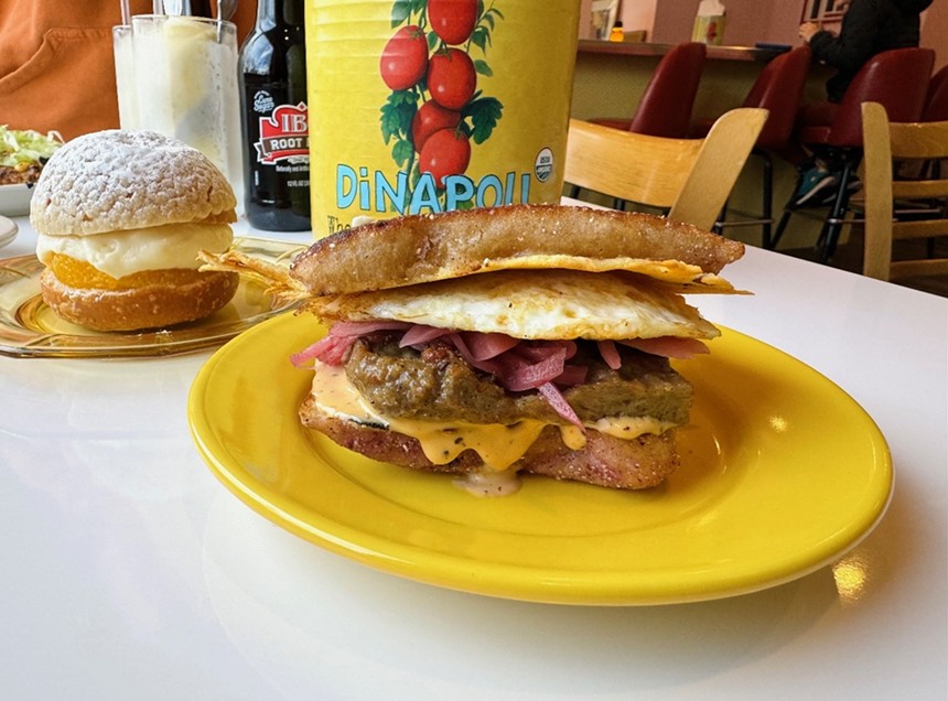 a breakfast sandwich on a yellow plate