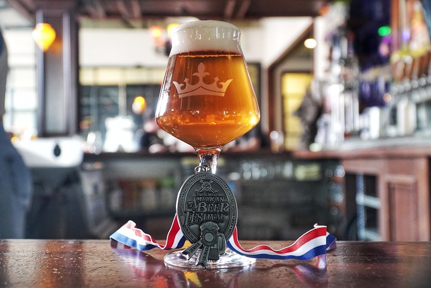 beer in a glass with a medal