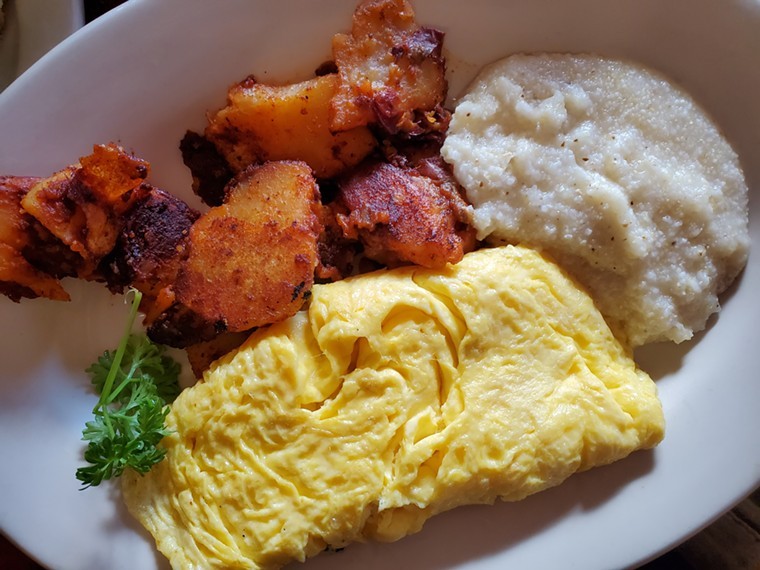 an omelet, fried potatoes and grits