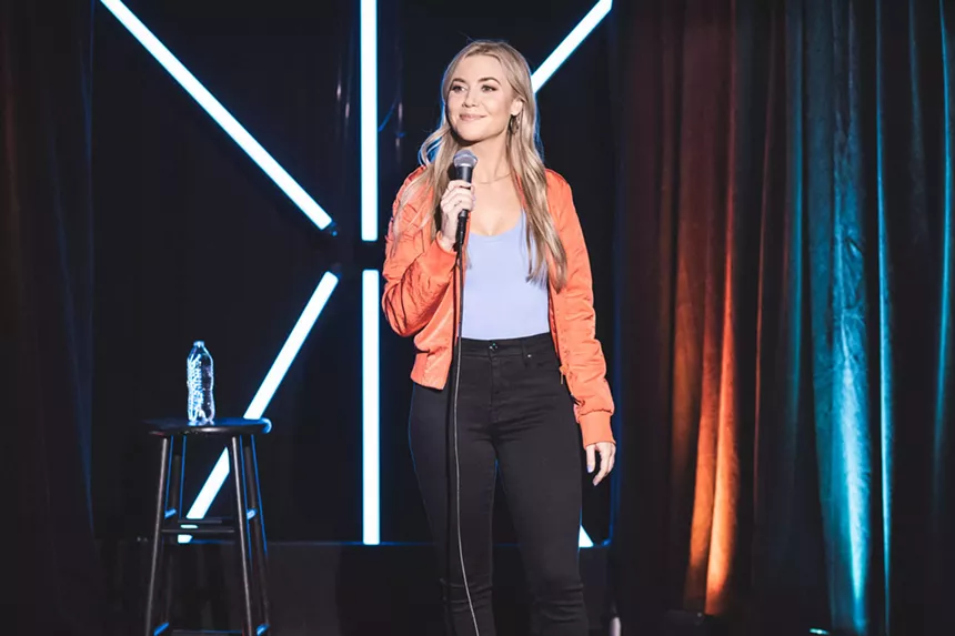 woman comedian at a microphone