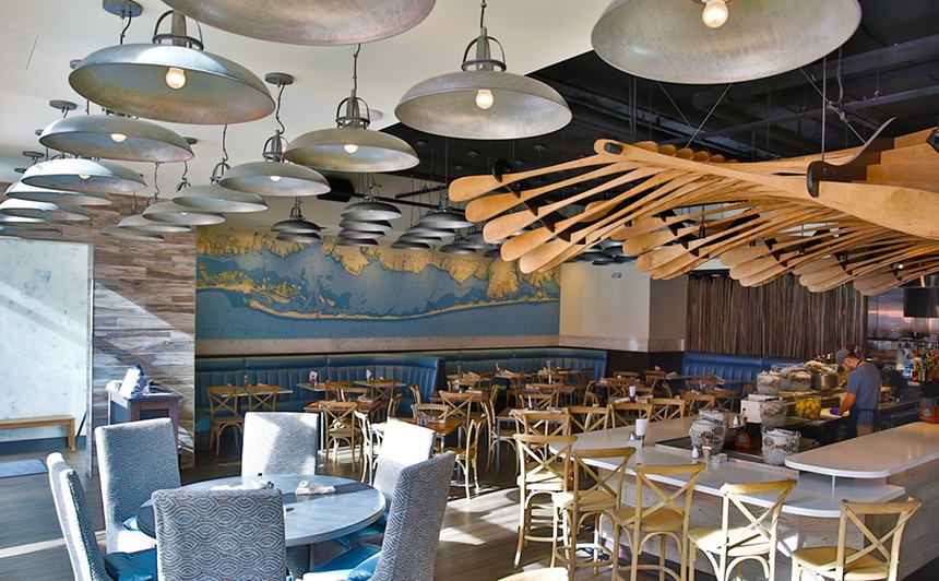 Numerous light fixtures and nautical-themed art pieces inside a dining room