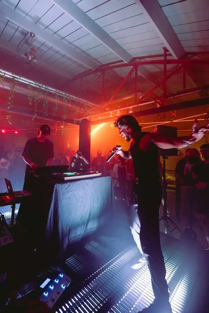 two djs performing