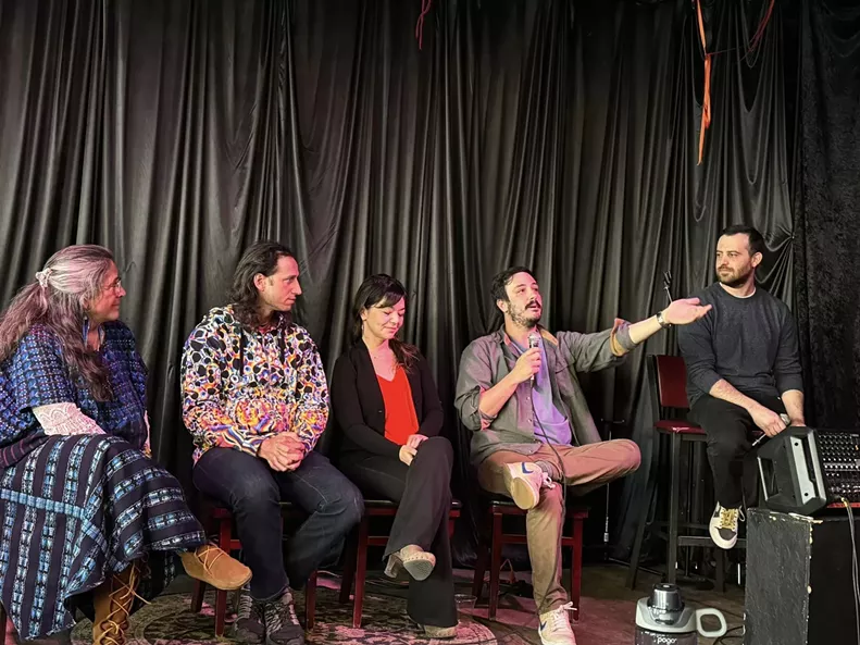 Panel of people talk on stage