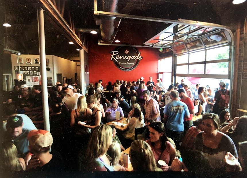 Crowded brewery with patrons.