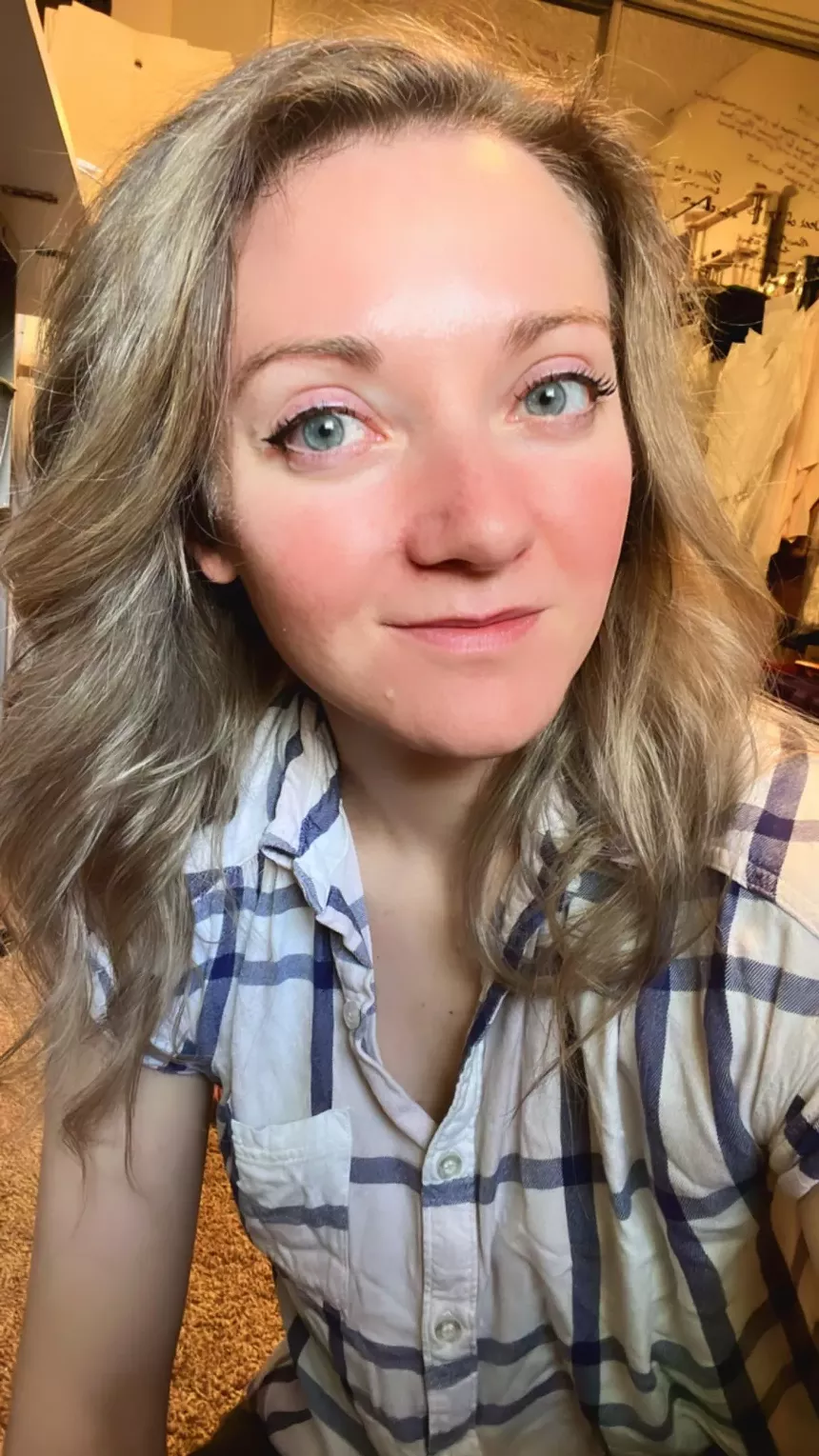 blonde woman smiling in a flannel
