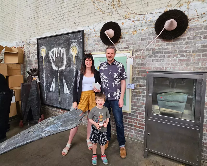 boy and parents with art.
