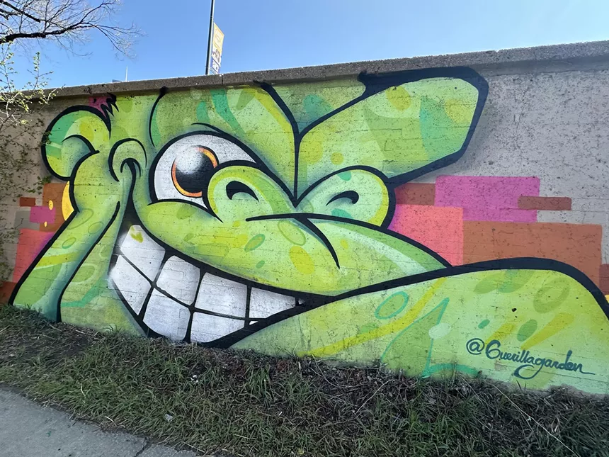 An art mural of a monkey figure.